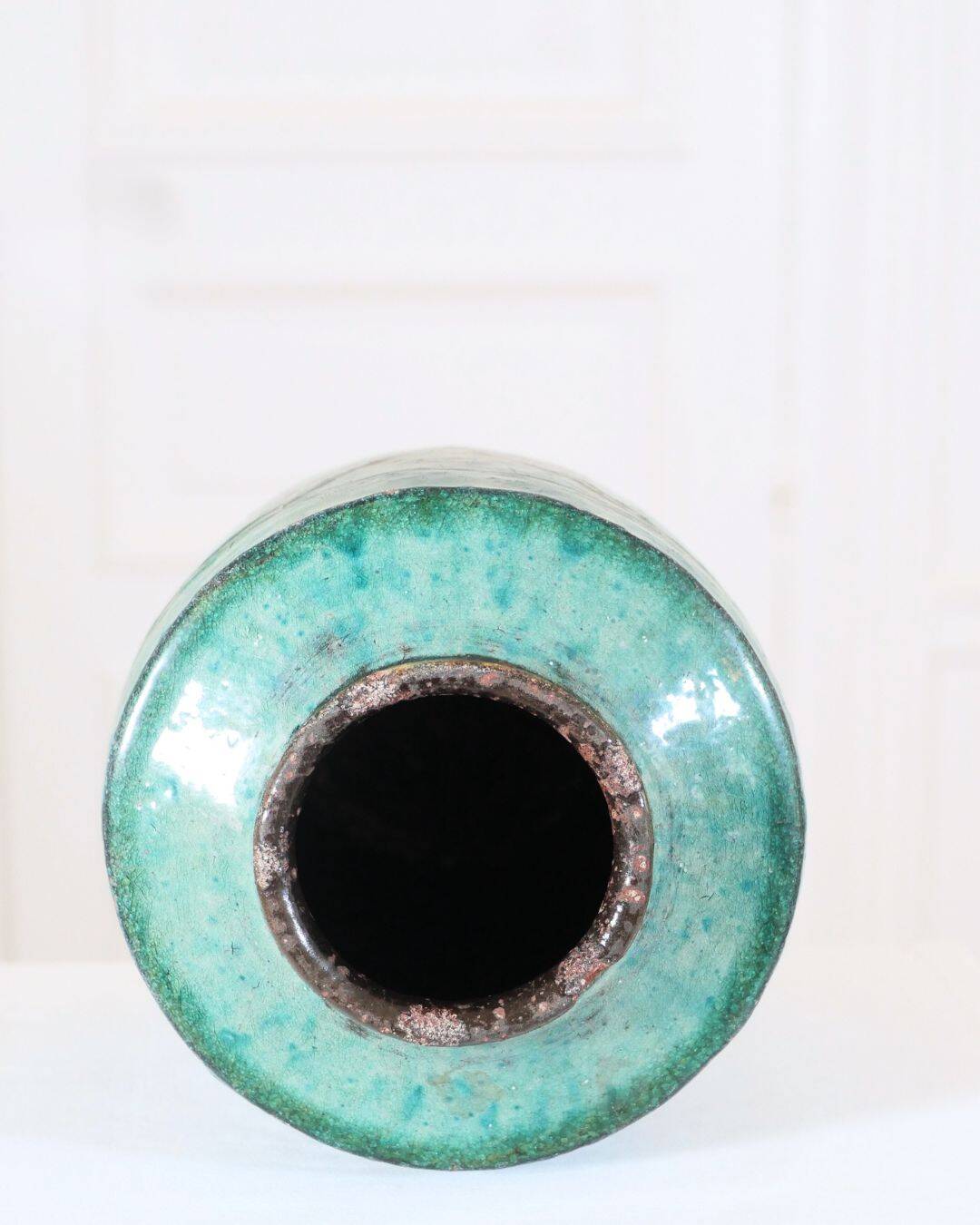 Chinese glazed earthenware vase with bird and flower decoration on a green background