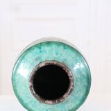 Chinese glazed earthenware vase with bird and flower decoration on a green background