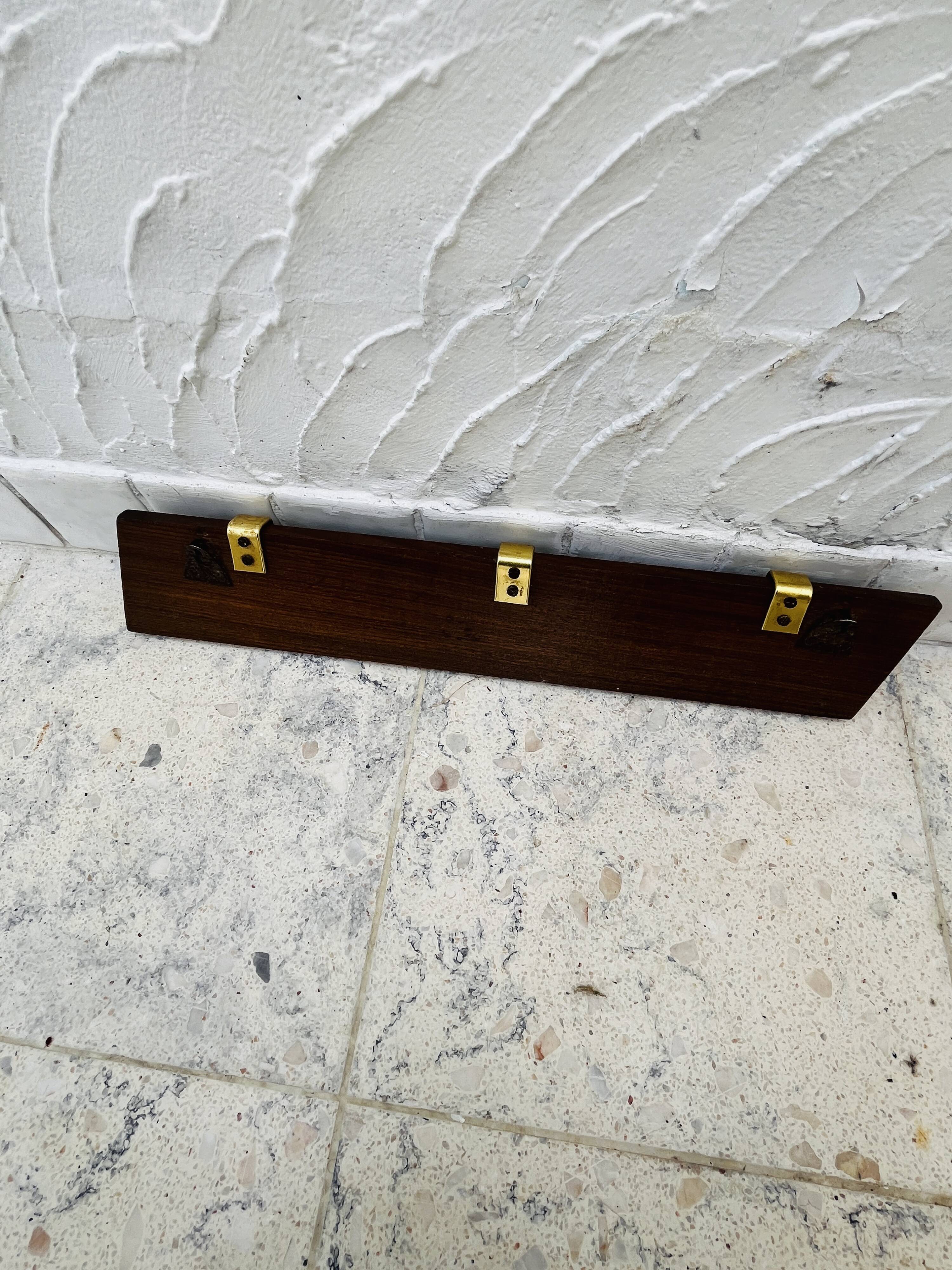 Vintage wooden and brass coat rack with 3 hooks from the 1960s.
