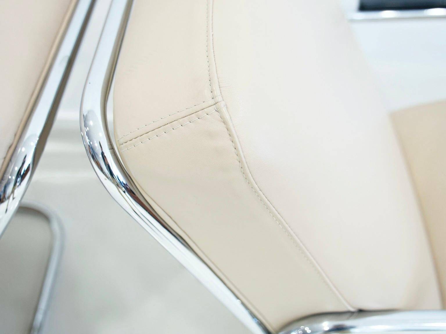 Pair of beige leather and tubular steel armchairs.