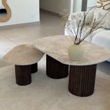 Oval coffee table duo travertine and fluted wooden legs.