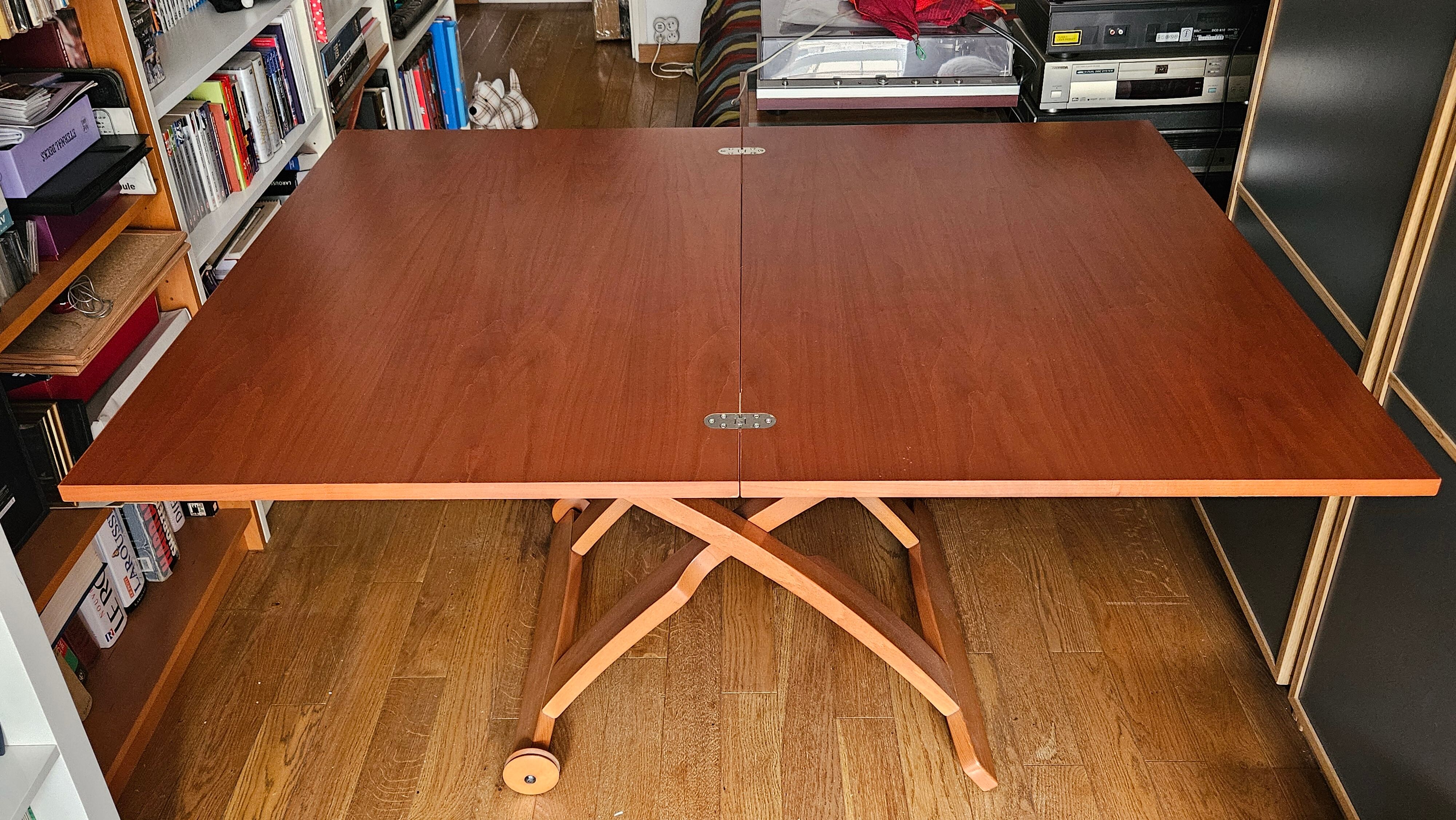 Wooden coffee table convertible into a dining table.