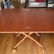 Wooden coffee table convertible into a dining table.