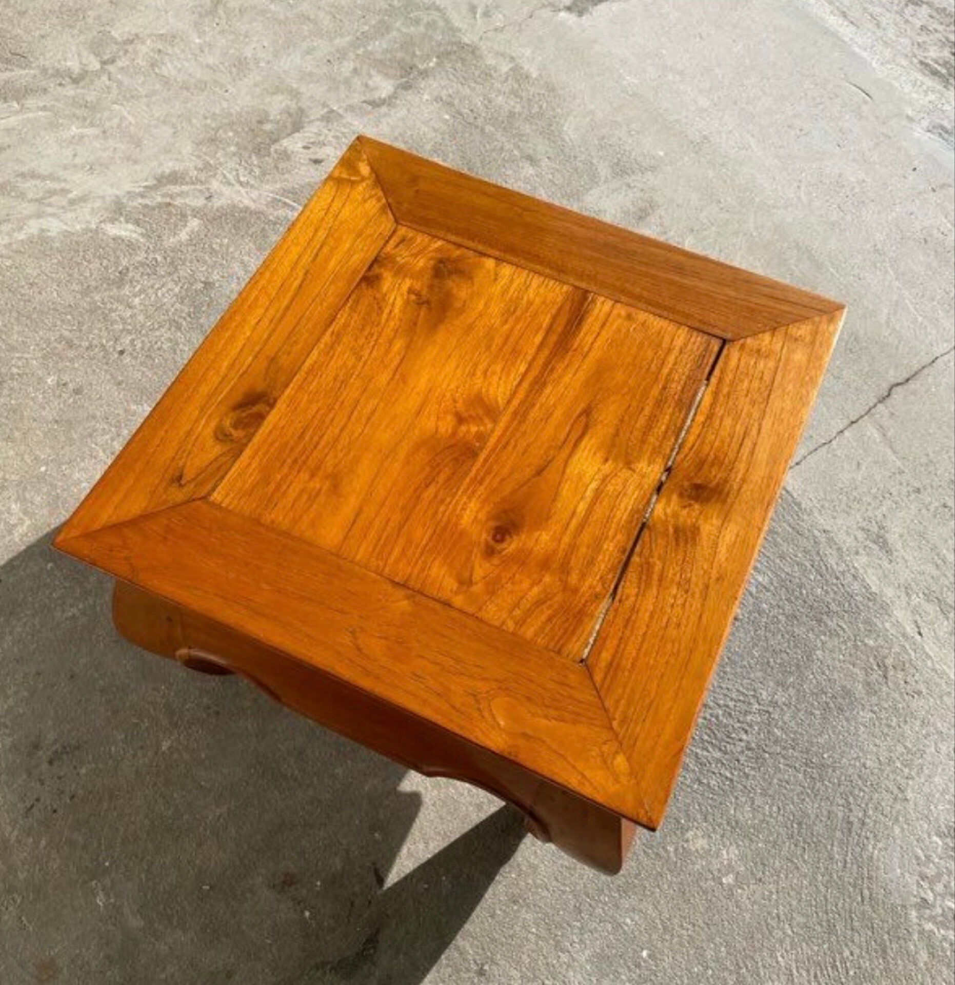 Small solid teak coffee table in opium style.