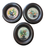 Set of three miniature flowers in a vase.