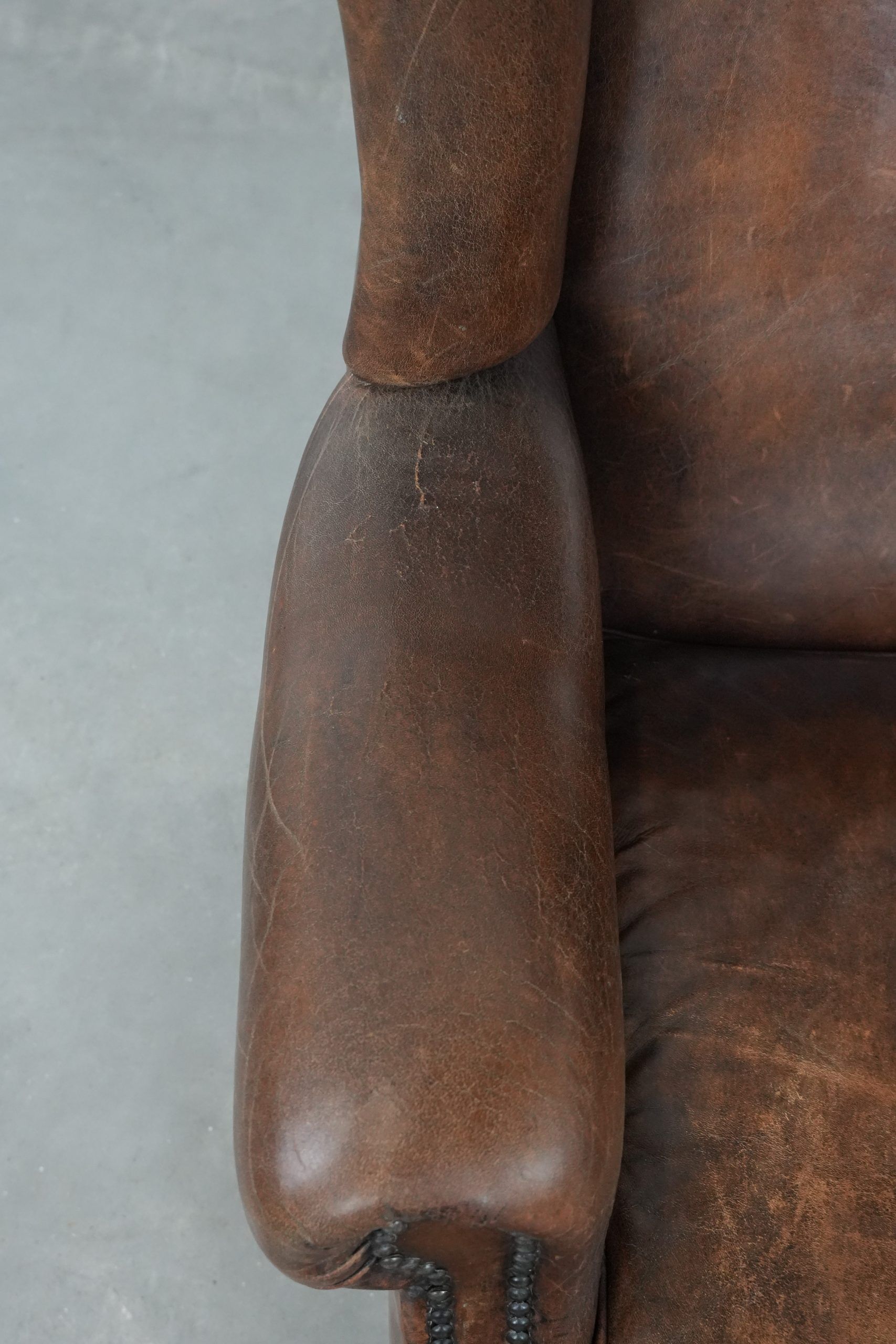 Vintage wingback armchair made of sheepskin leather with beautiful colours
