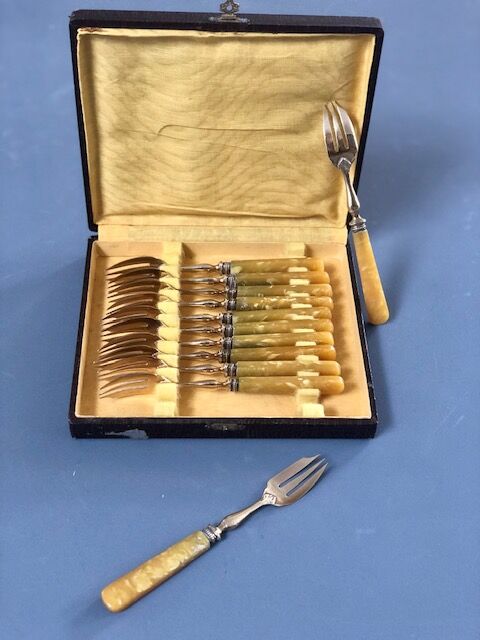 Brass and yellow galathite cake forks