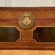Beautiful vintage Chinese trunk in wicker, black and gold lacquered wood, and brass.