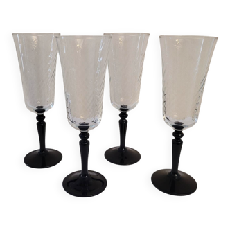 4 clear glass flutes with black stems. 1960–1970. 4 clear glass flutes with black stems.