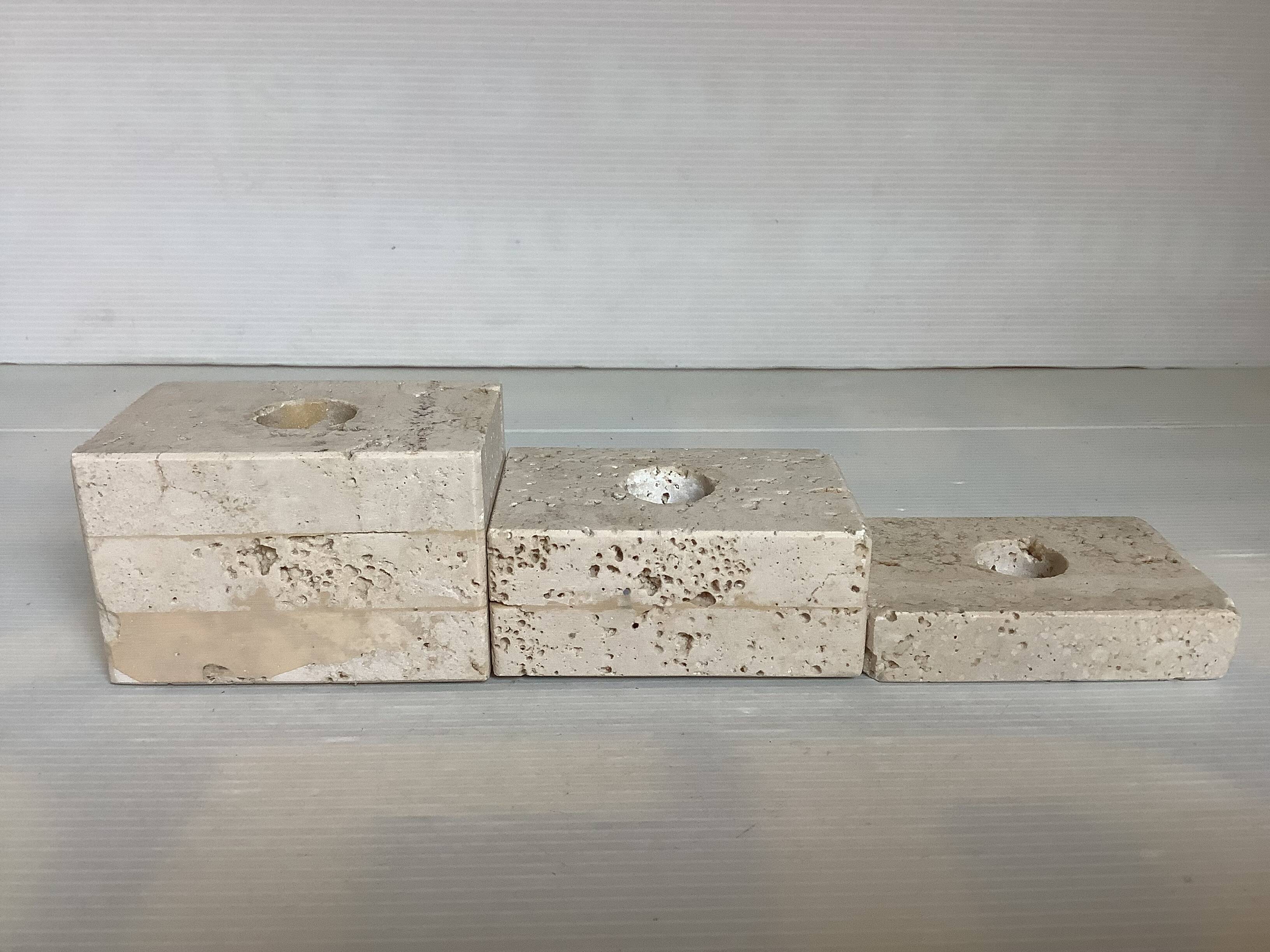 Trio of travertine candlesticks