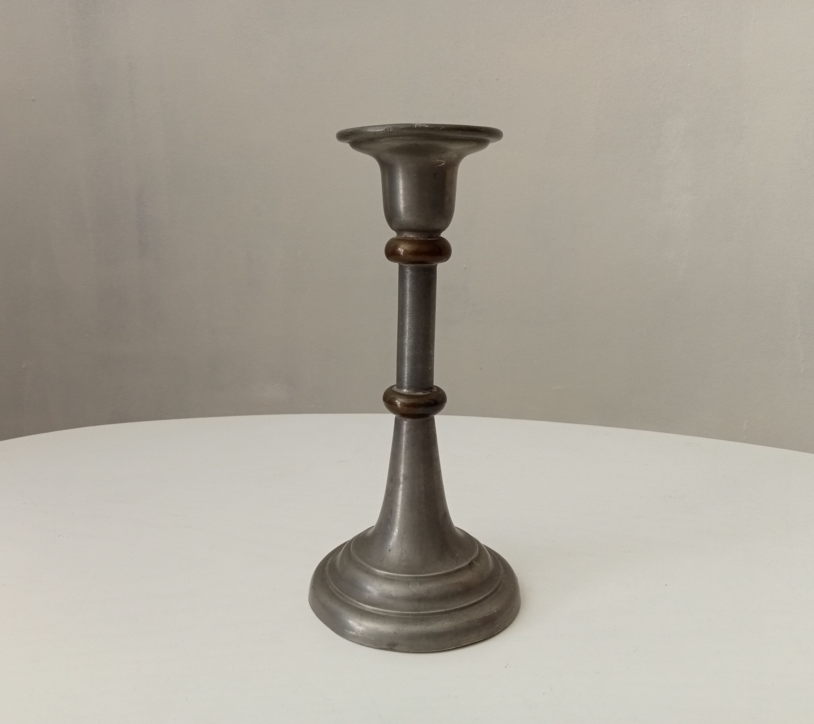 Antique candle holder in pewter and brass
