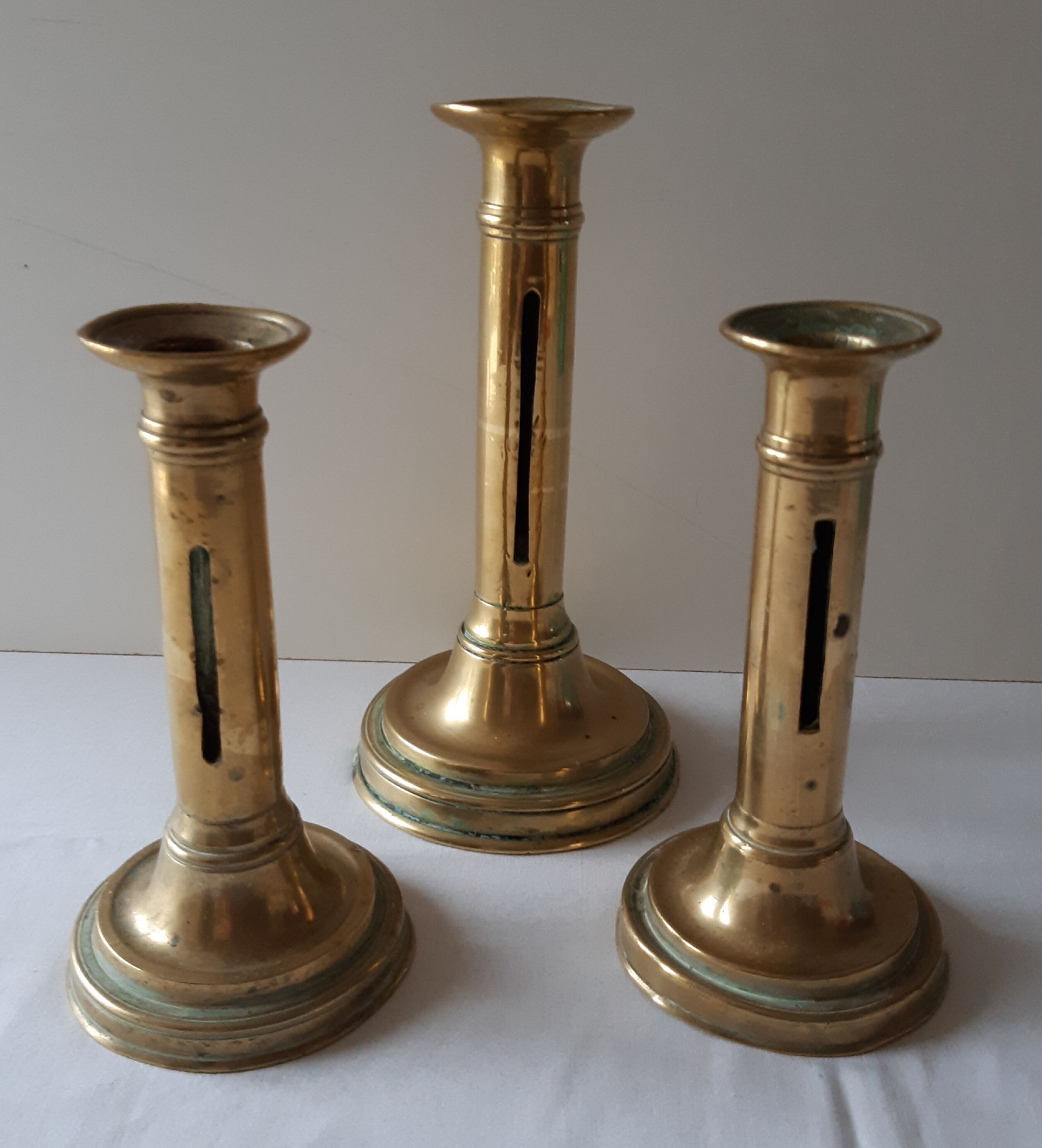 Lot of three old brass candlesticks