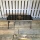 Vintage black and gold glass coffee table with conical legs from the 1940s.