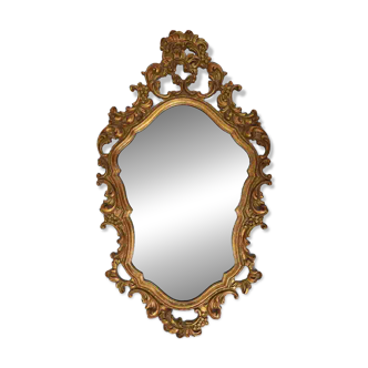 Baroque style oval wall mirror in gilded wood, France