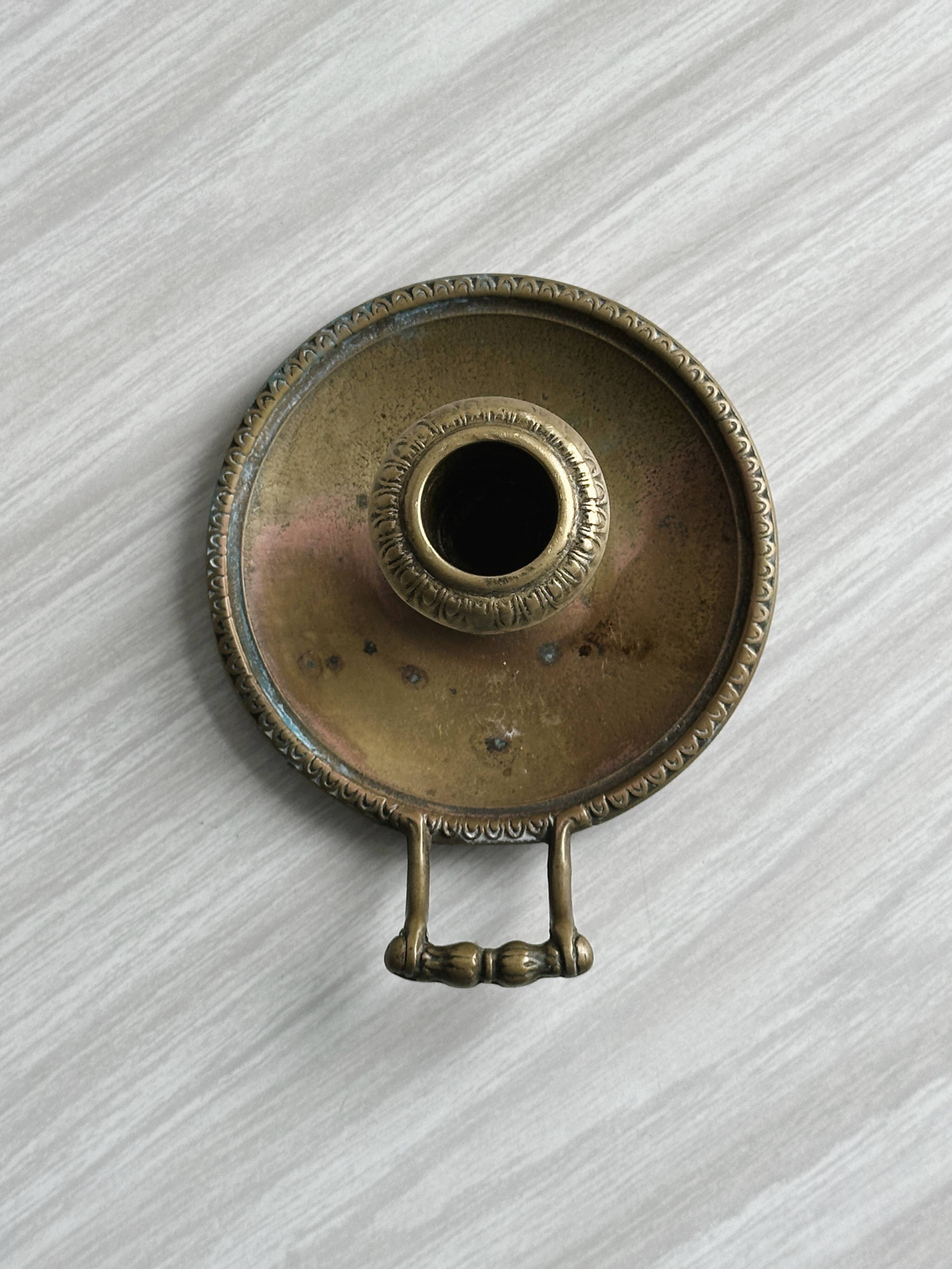 Brass candle holder with handle.
