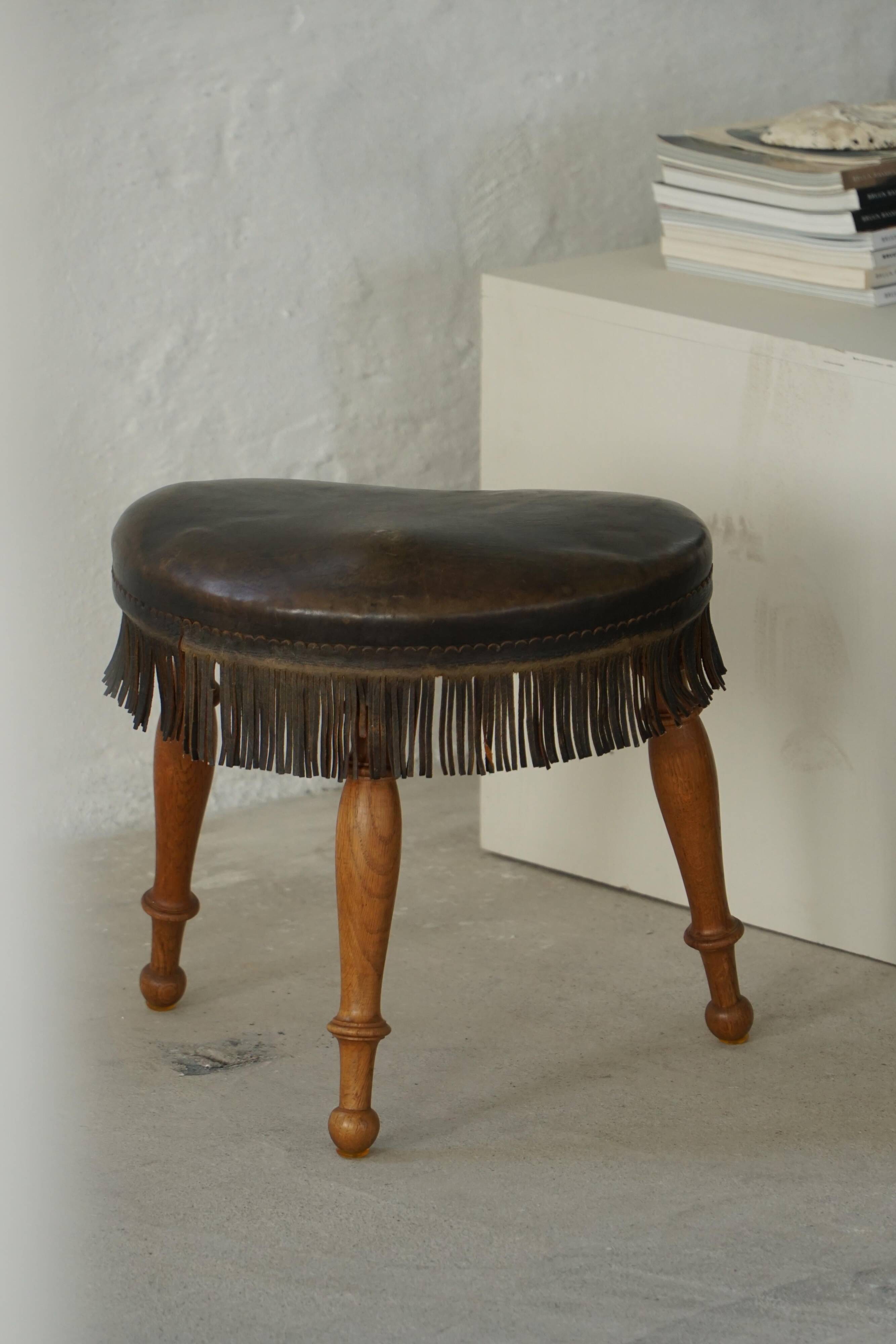 Danish oak tripod stool from the early 20th century with leather fringe, 1930s.