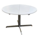 White dining table with a central pedestal, extendable, from the 1970s.