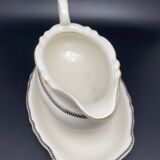 Porcelain sauce boat with black and gold checkered border