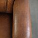 Comfortable characterful sheepskin armchair finished with decorative nails