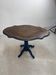 Wooden gueridon with a violin-shaped top in Rio rosewood, central base resting on four legs, reinterpreted in Baltic blue.