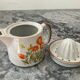 Vintage stoneware jug and its citrus juicer.