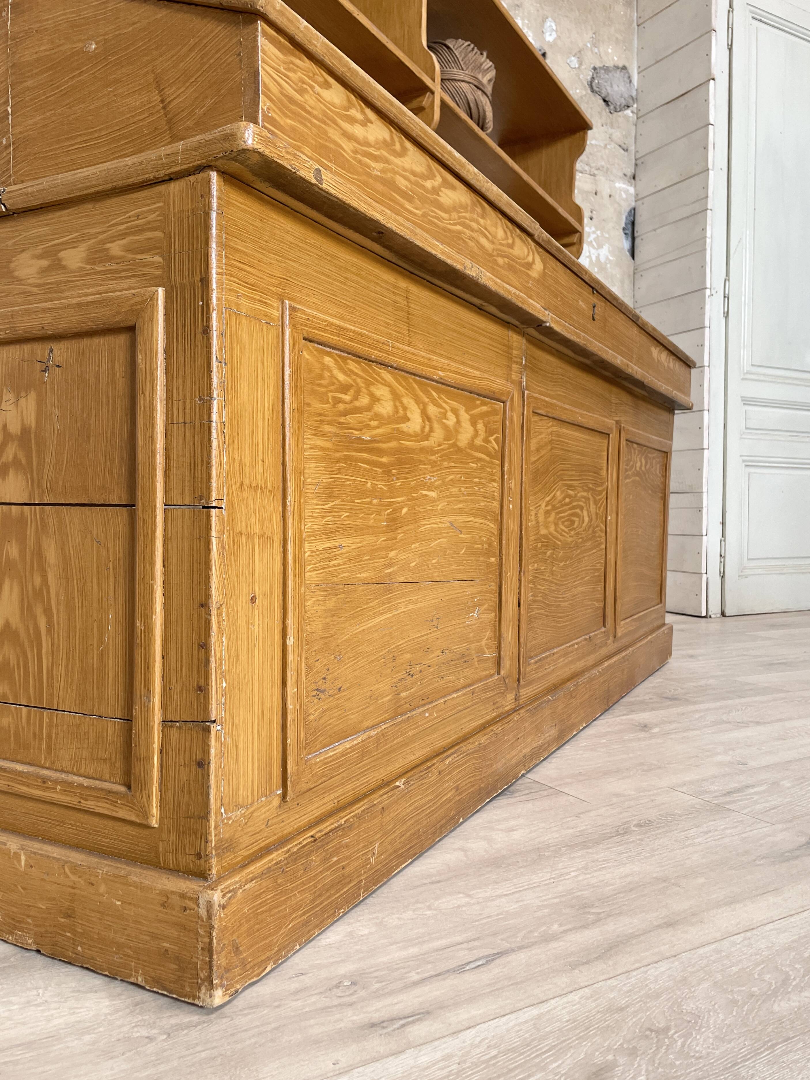 Wooden hardware cabinet painted with wood effect, circa 1940.