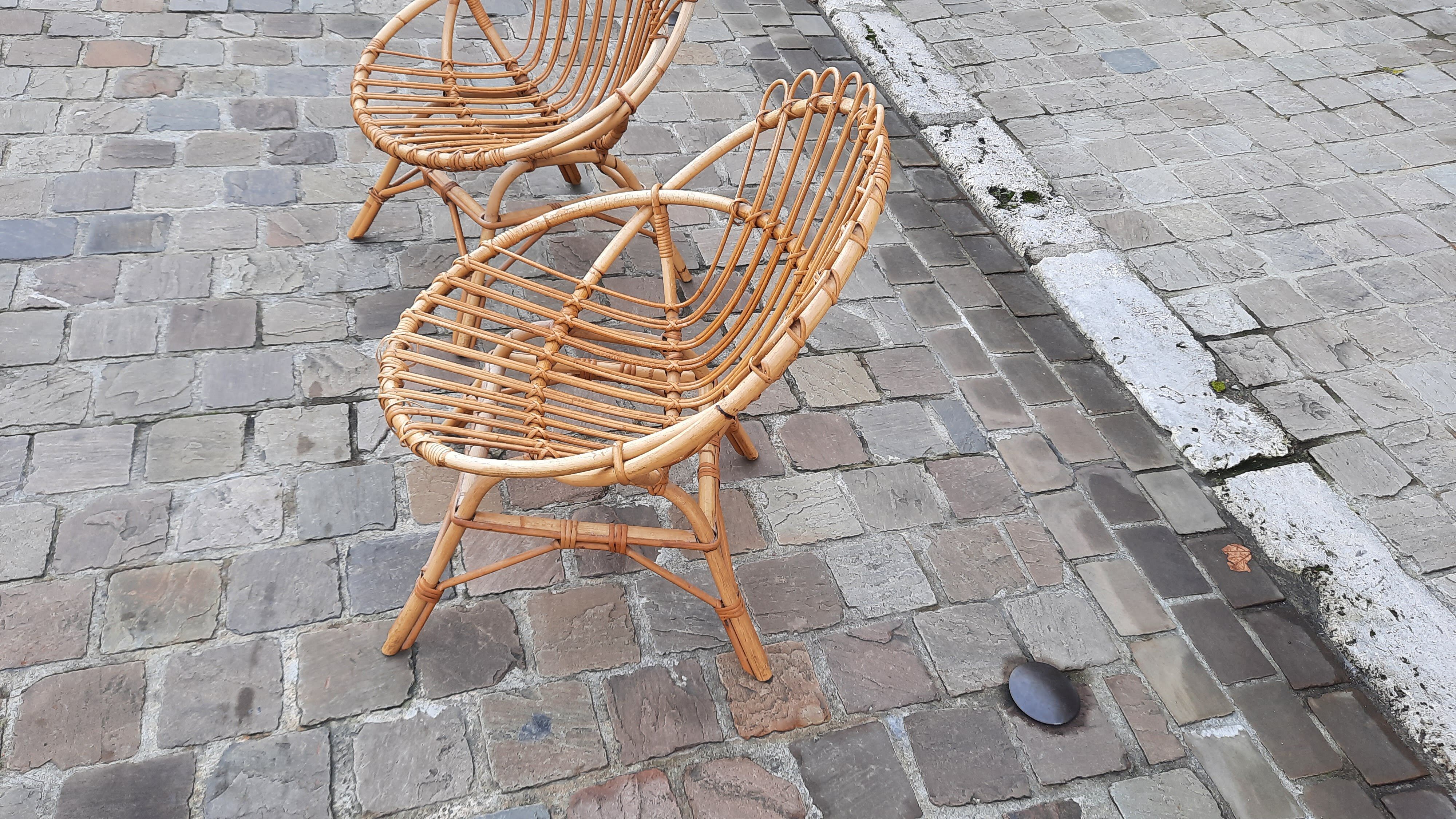 Pairs of shell rattan armchairs from the 50