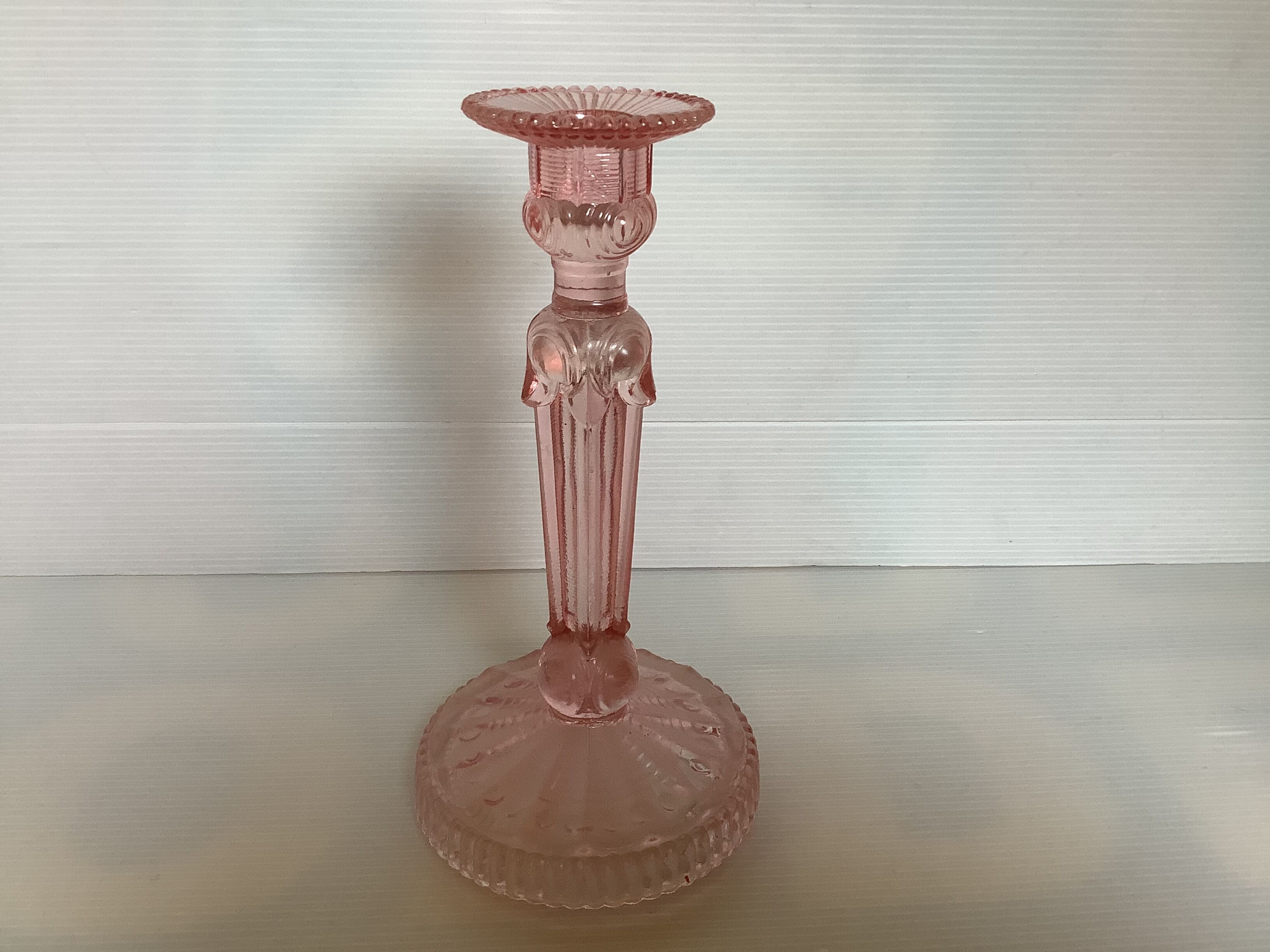 Old pink glass candlestick in Rosaline style.