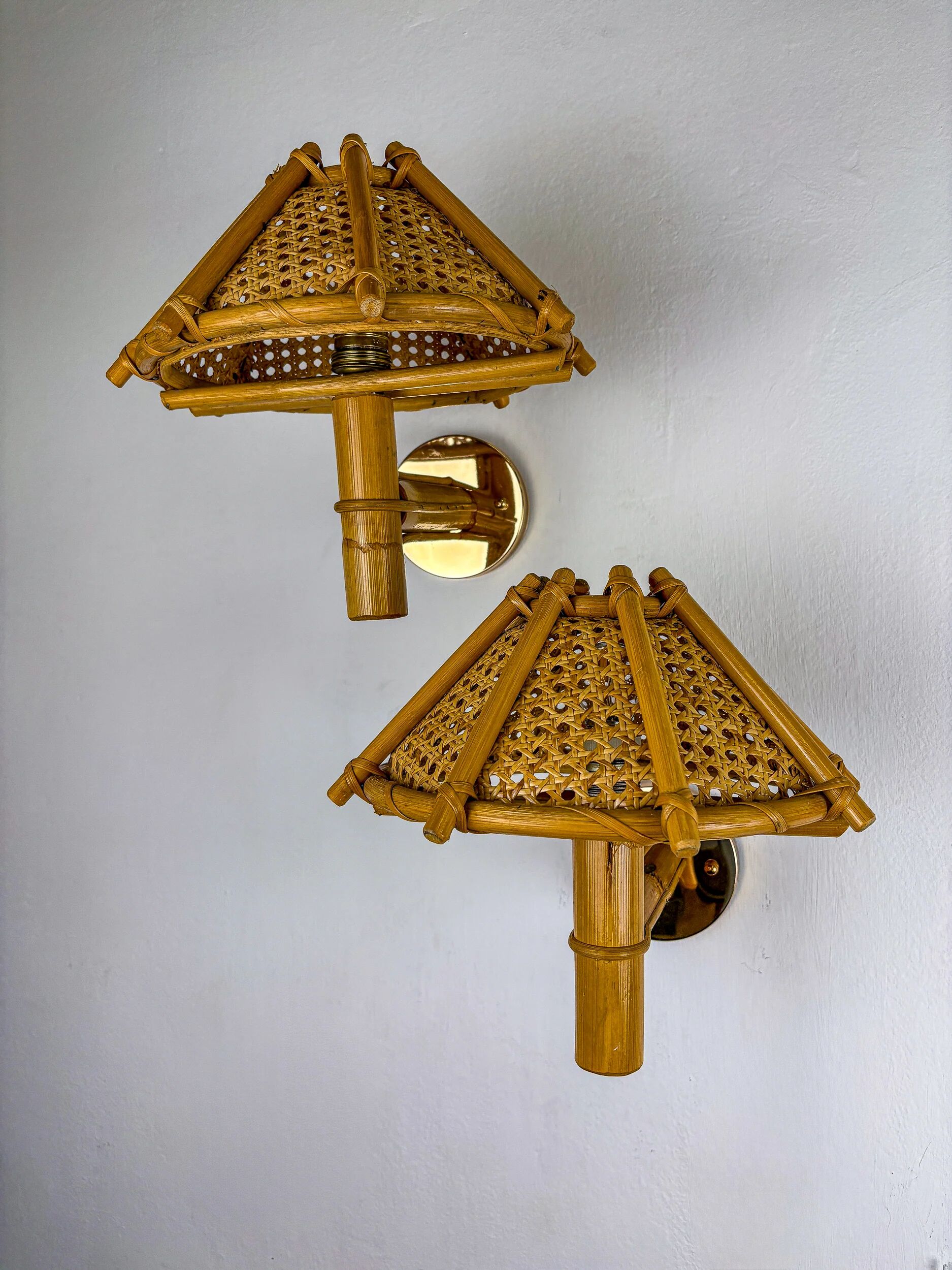 Pair of rattan bamboo wall lights with woven wicker shades, Italy, 1960s
