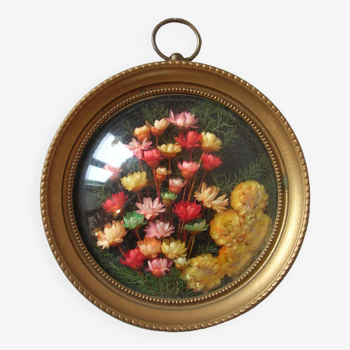 Old medallion frame bouquet of dried flowers glass and plastic retro decoration