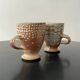 Set of 2 enamelled stoneware mugs with stylised polka dots.