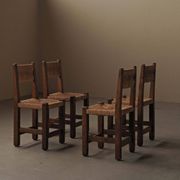 Set of four modernist chairs in oak and straw, France, circa 1960.