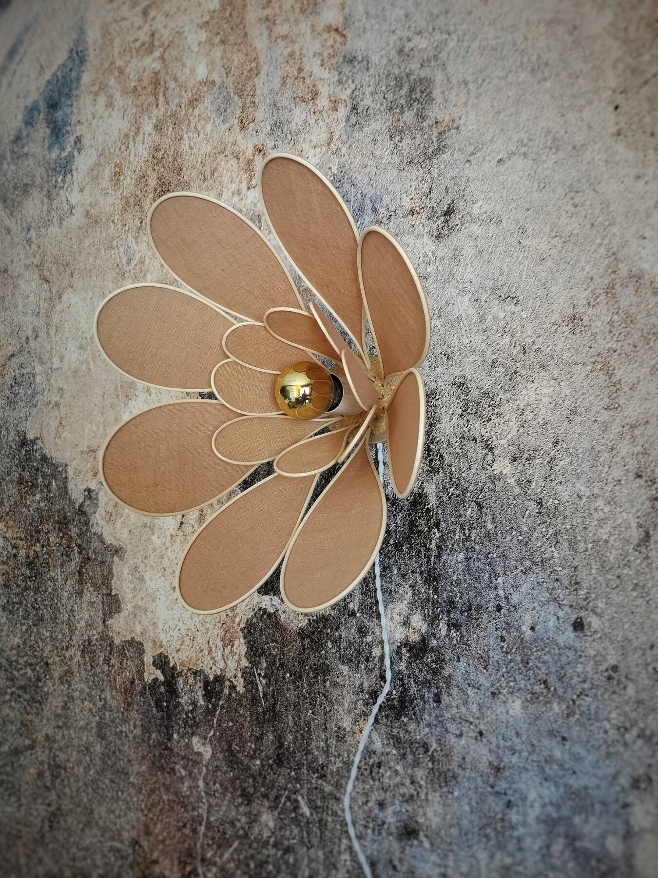 Flower wall light made of rattan and nude linen petals