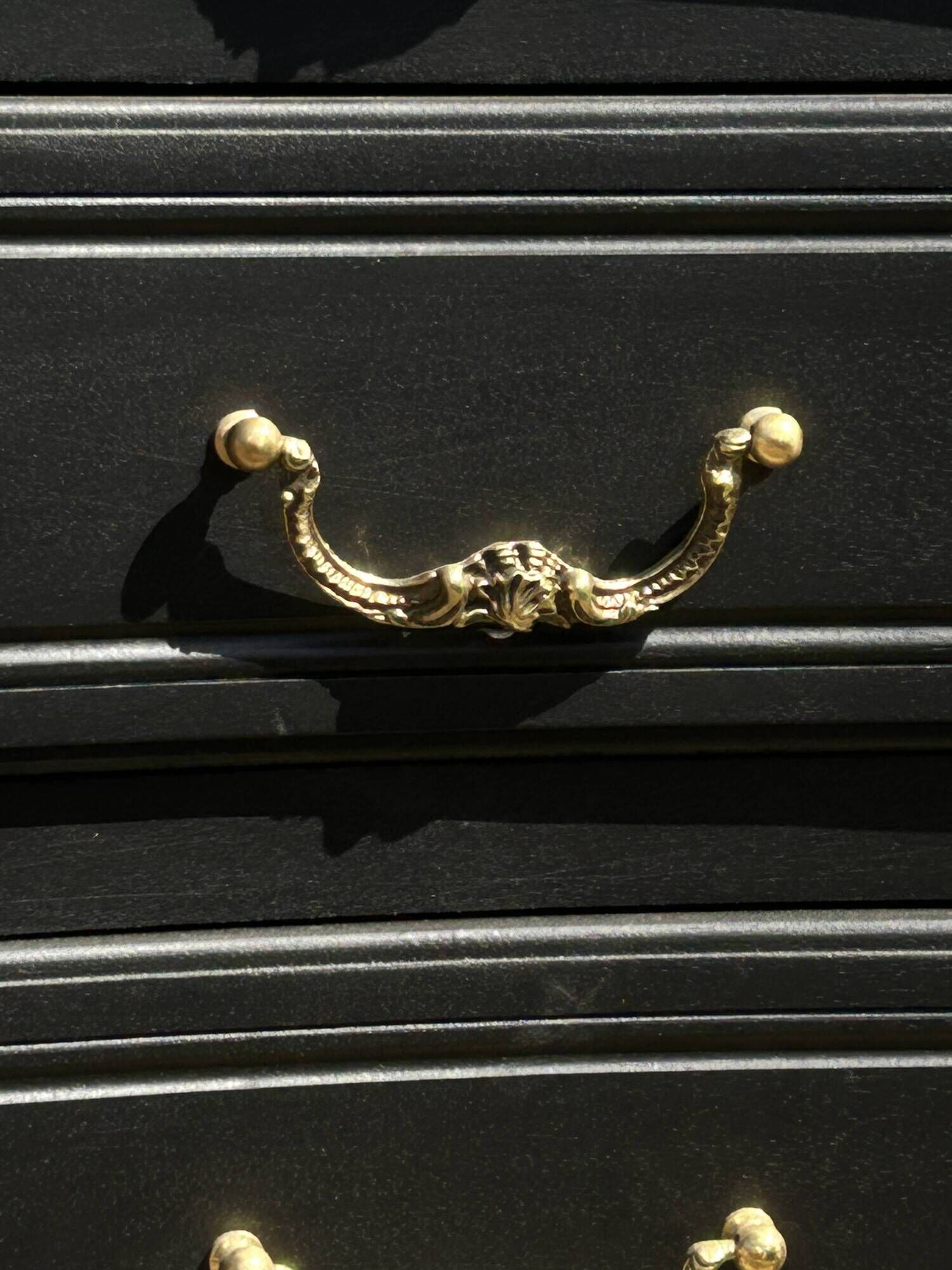 Louis XV style black lacquered chest of drawers with four drawers.