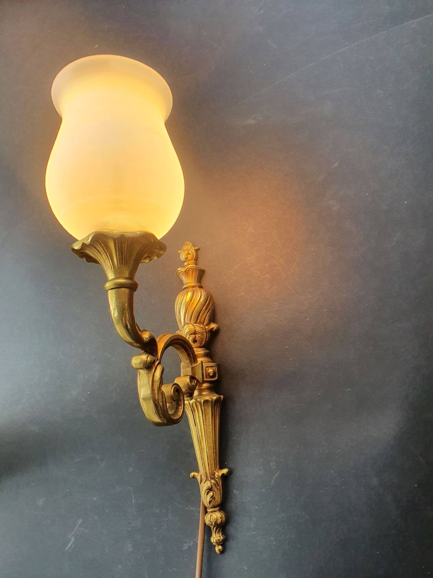 Three large vintage torch wall sconces.