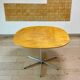 Dining table with a star-shaped six-legged base by Arne Jacobsen for Fritz Hansen.