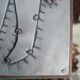Curious riveted metal mirror 40x40cm