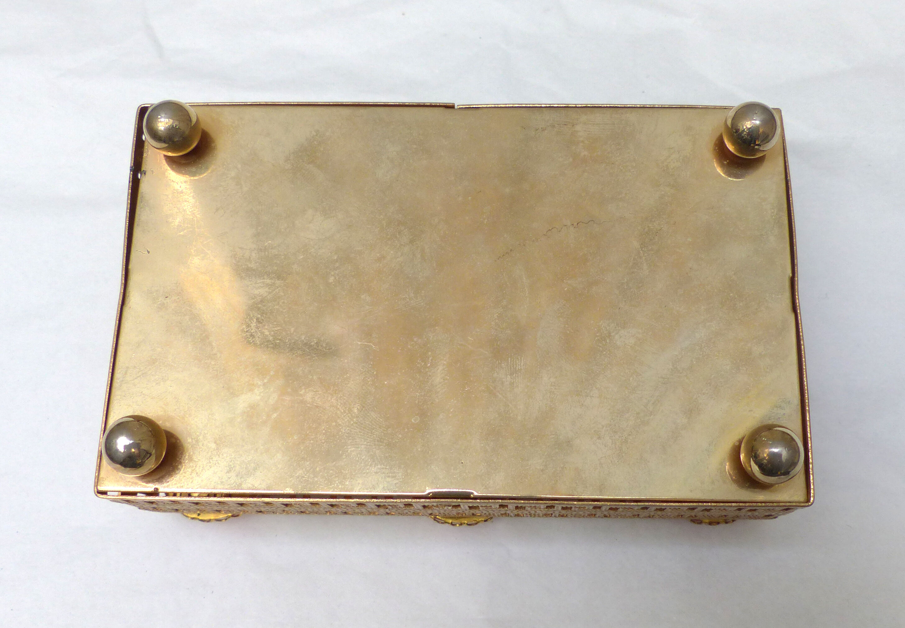 Golden metal catchall with pink stones
