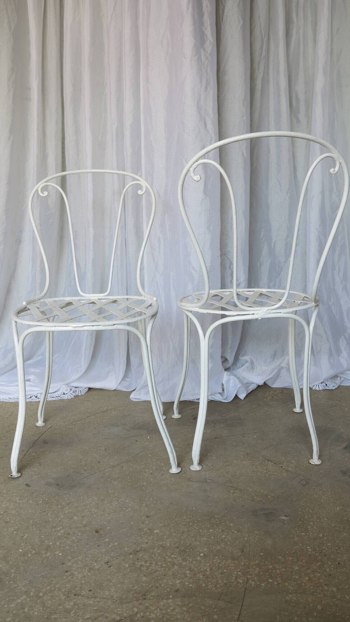Pair of antique garden chairs, wrought iron, white paint.