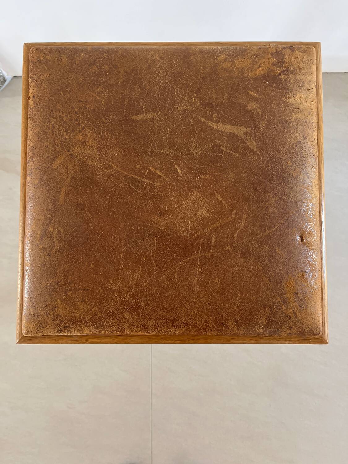 Vintage stool from the 60s with aged leather seat