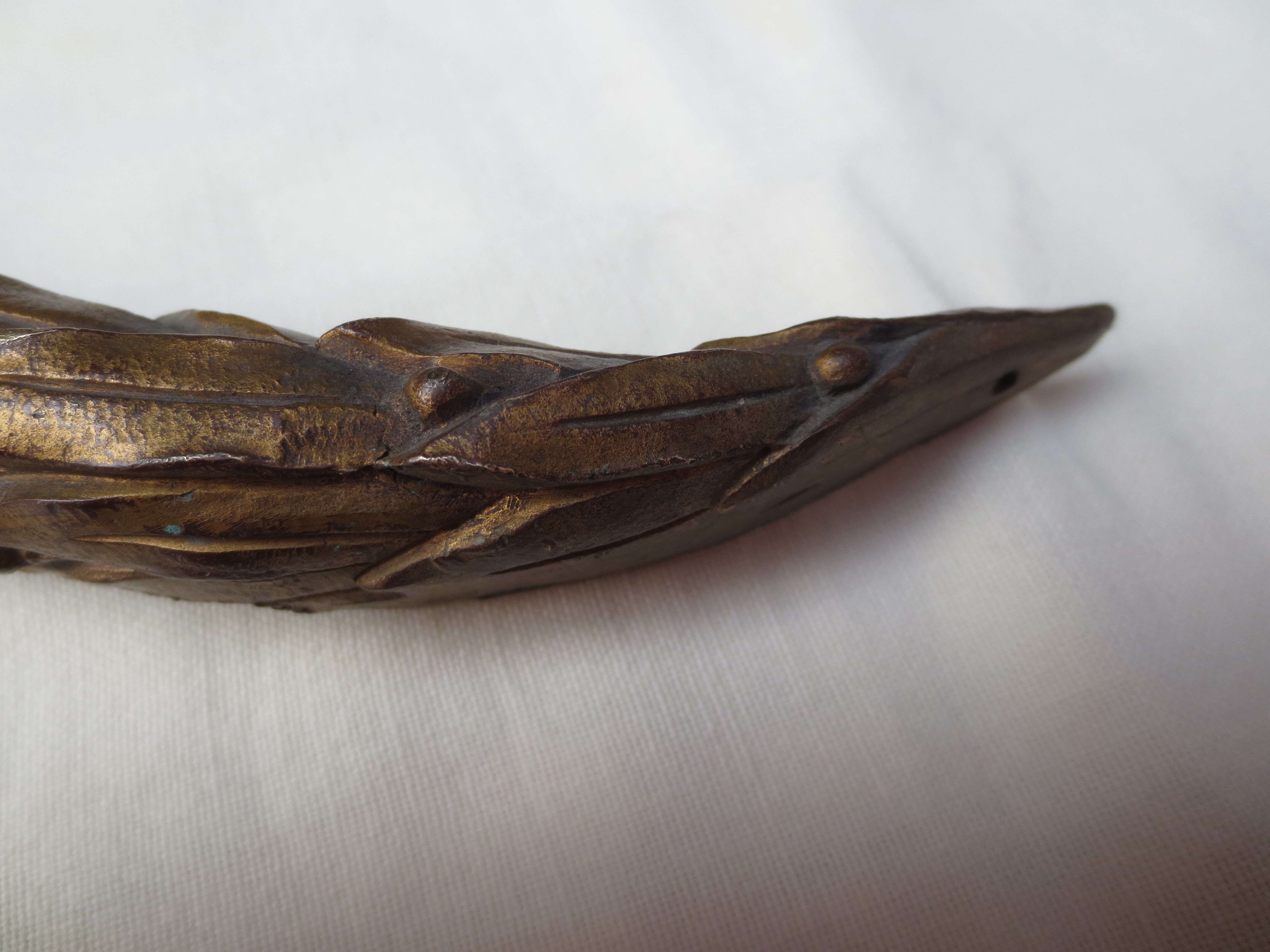 old bronze curved pediment