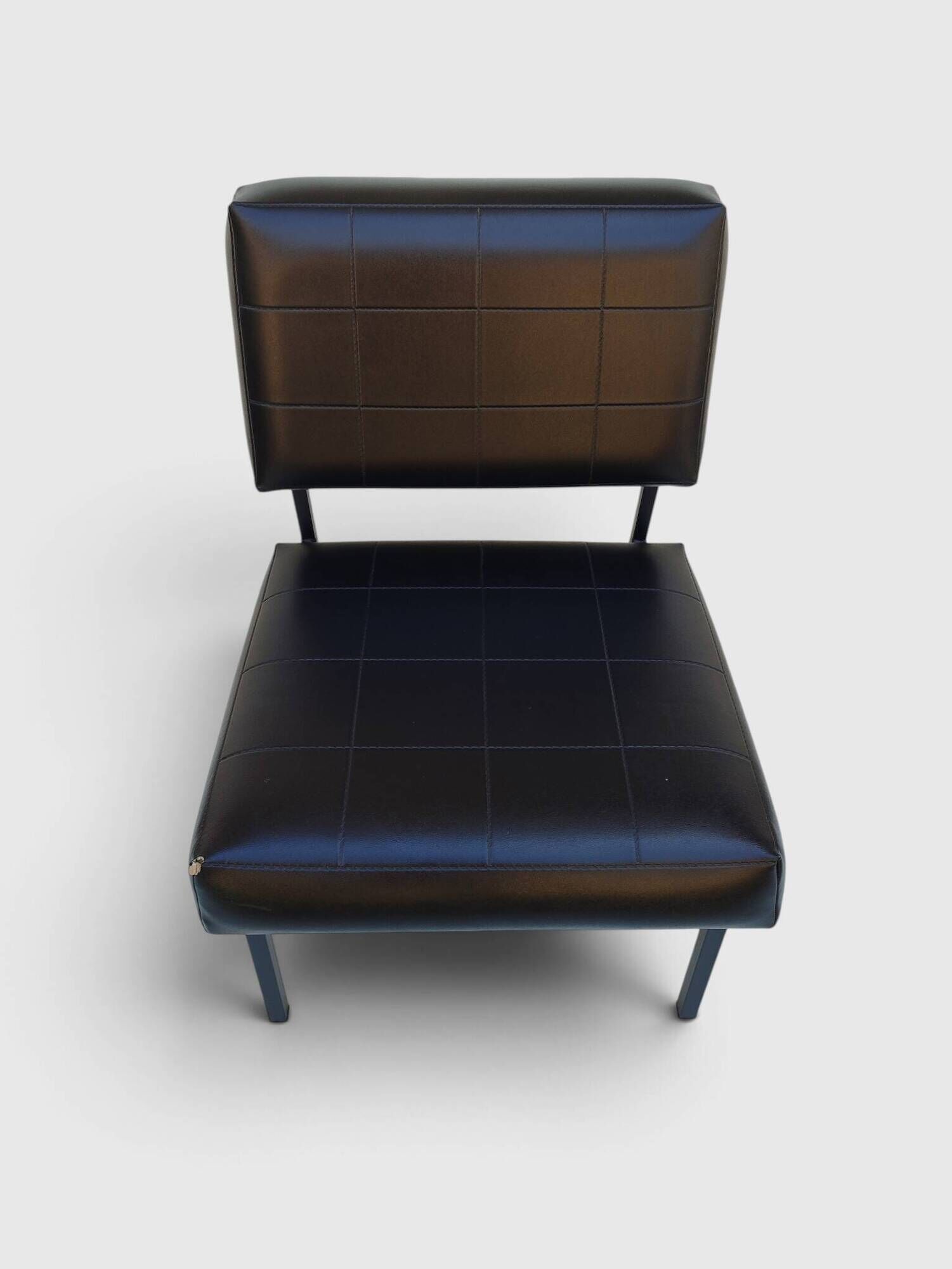 Modernist armchair in black faux leather and metal – 1960s
