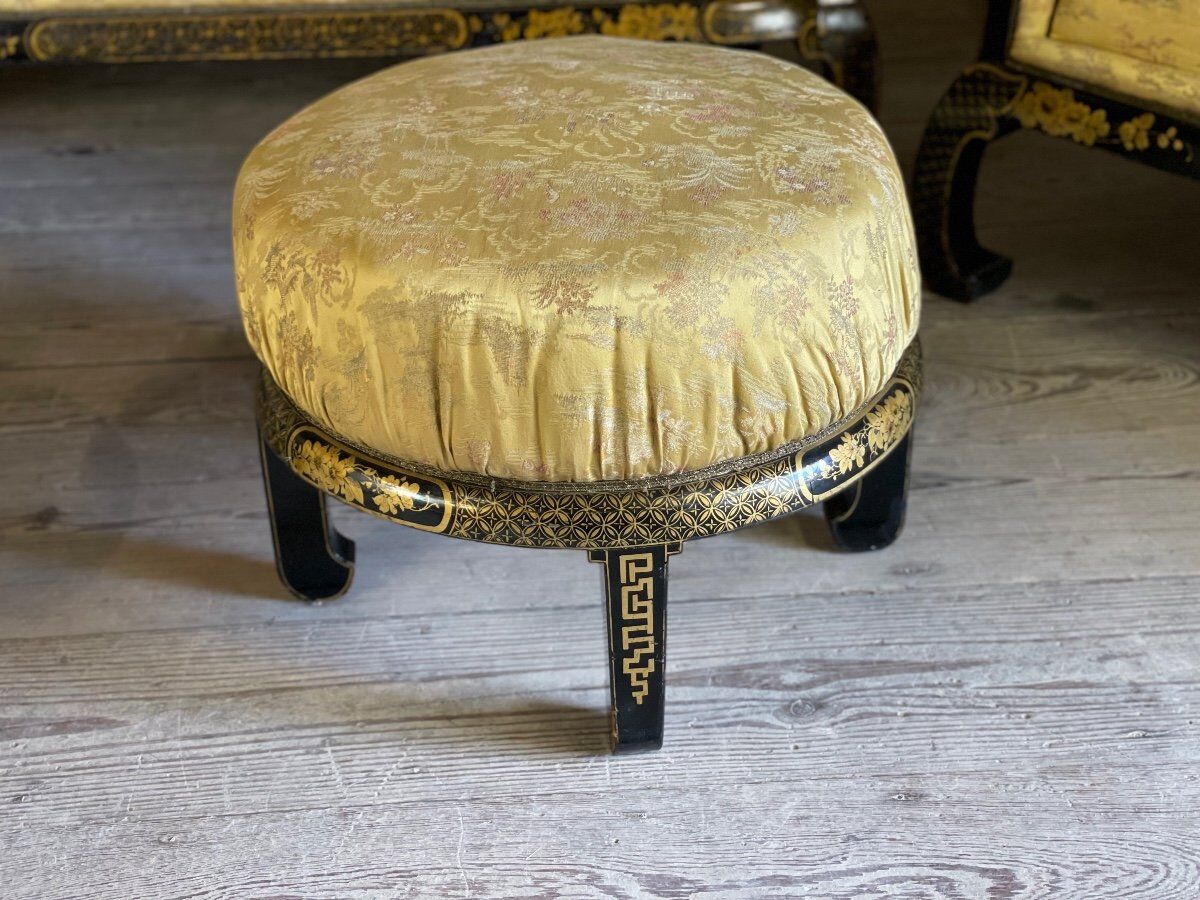 A set of two armchairs, a sofa and two poufs in lacquered wood with gilded chinoiserie decoration.