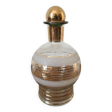 Glass carafe with white granite parts and gold edging. Glass stopper