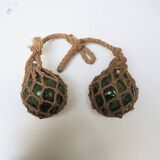 Old glass fishing float with rope net