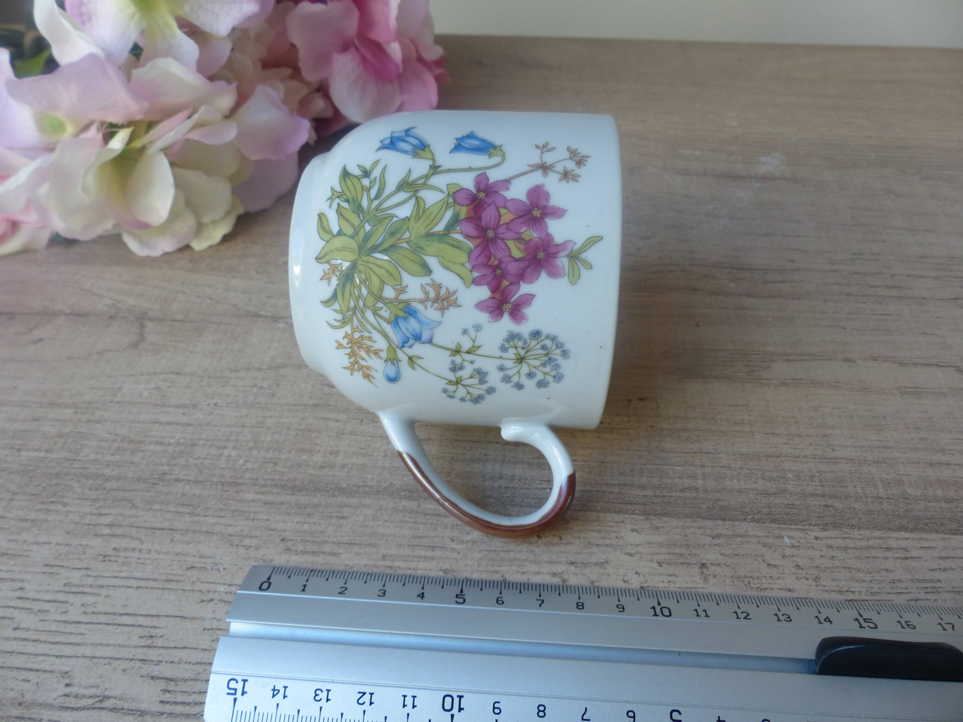 Old ceramic flower cup, vintage bohemian field flowers
