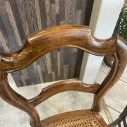 Pair of antique caned and wooden chairs from the 1900s.