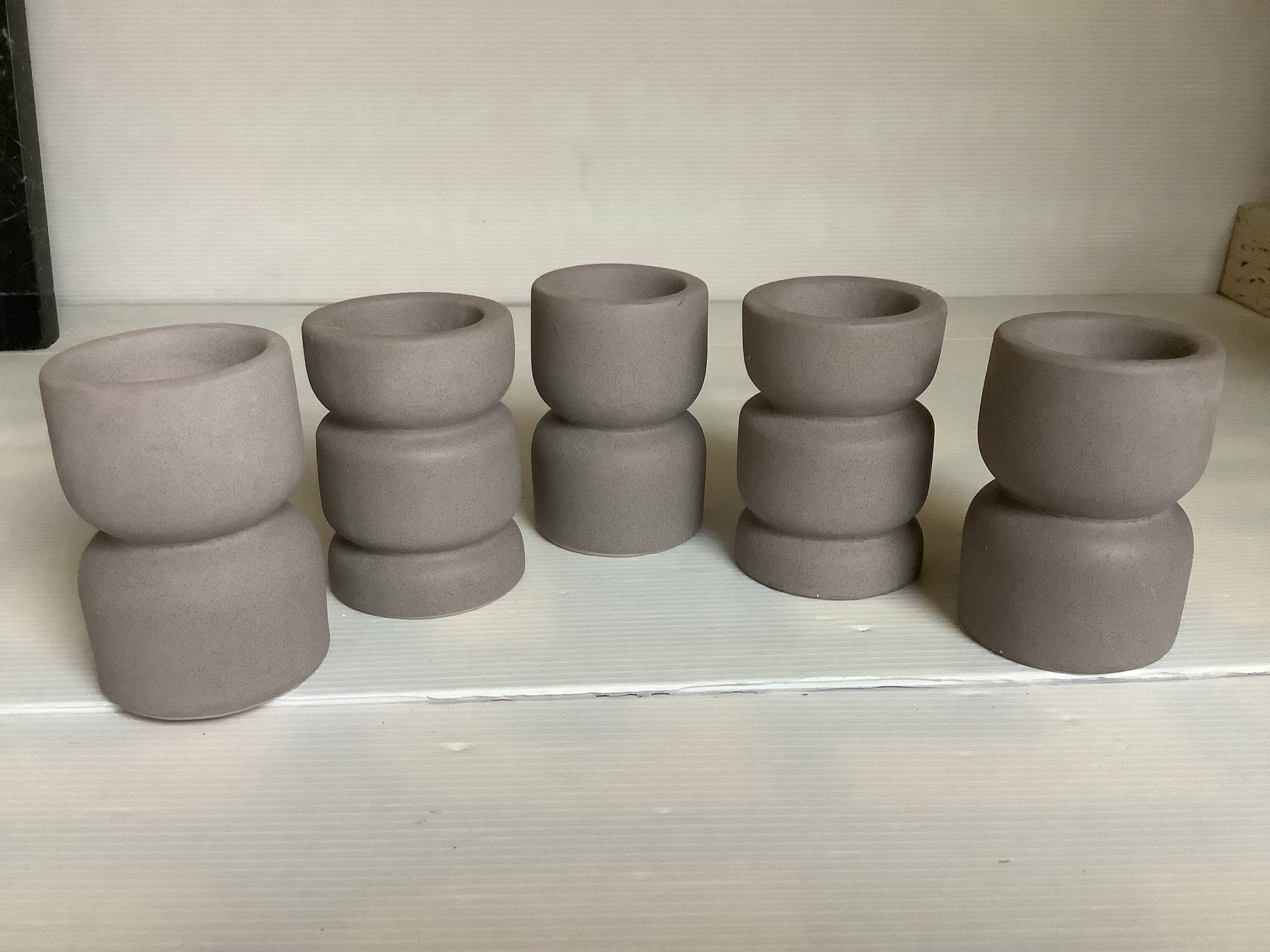 Five matte gray candle holders