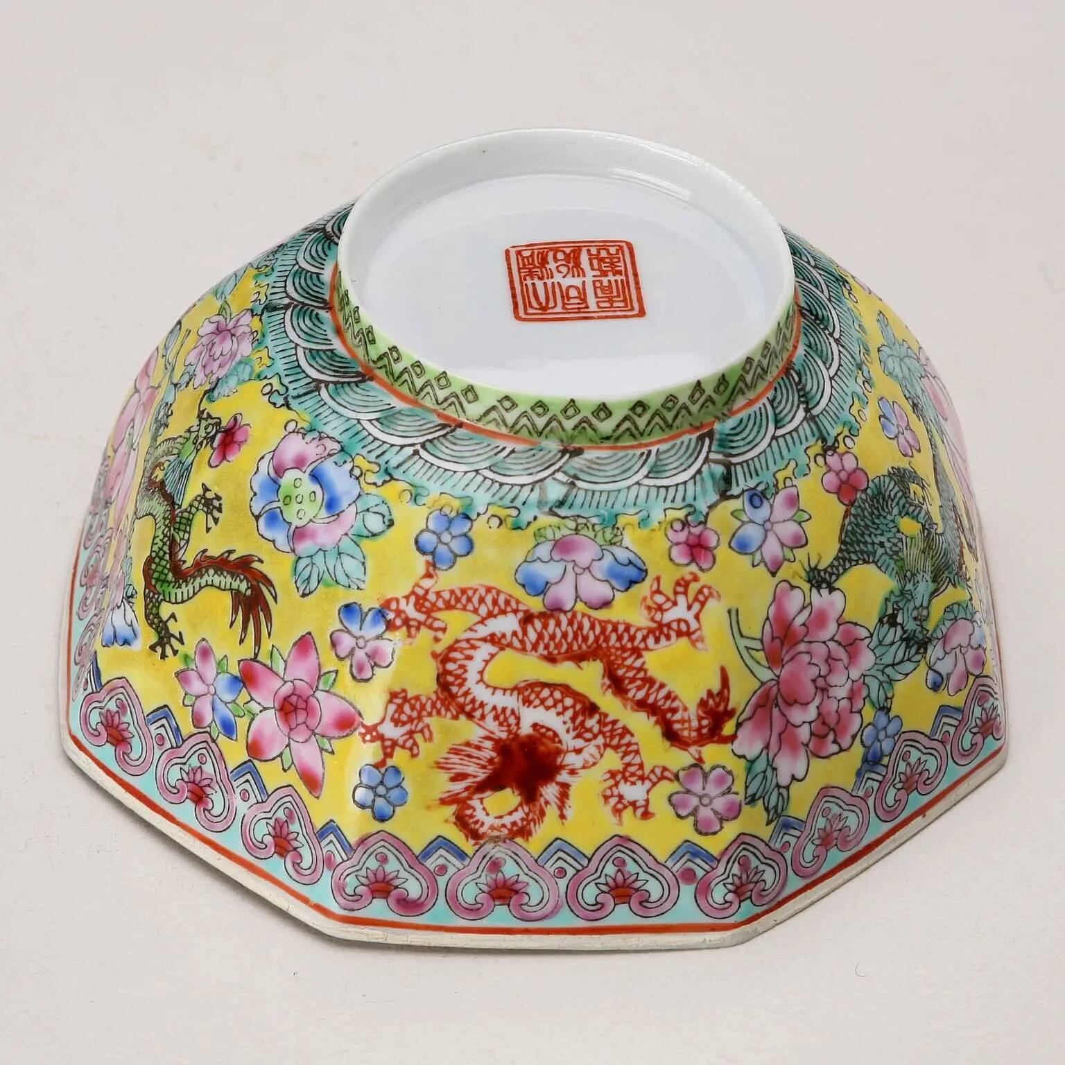 Vintage porcelain bowl decorated with dragons and flowers, China, 1980s.