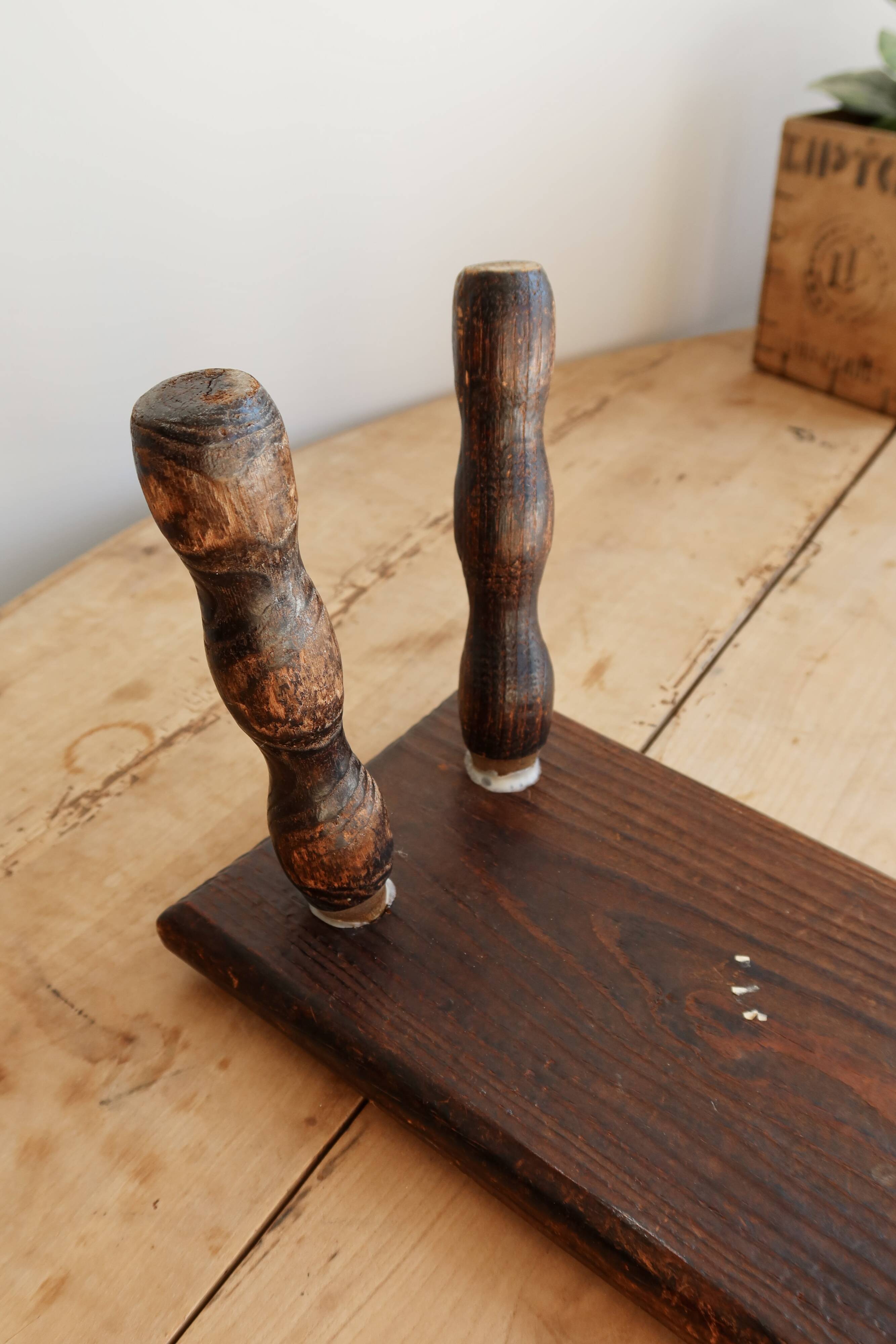 Vintage rectangular stool in dark wood with turned legs.